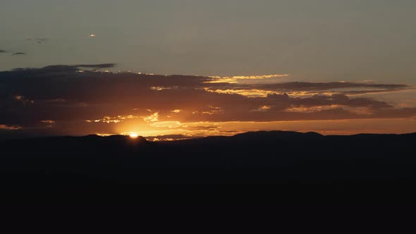 Golden Sunrise Behind Thin Layer of Clouds Timelapse Wide Shot