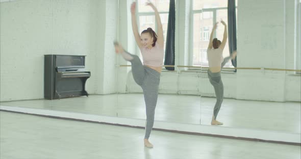 Cheerful Woman Practicing Expressive Dance in Studio alt