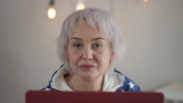 Front View Absorbed Mature Modern Woman Searching Music on Laptop Start Dancing alt