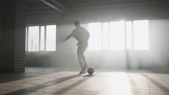 Teenager Boy Football Soccer Player Practicing Tricks Kicks and Moves with Ball Inside Empty Covered alt