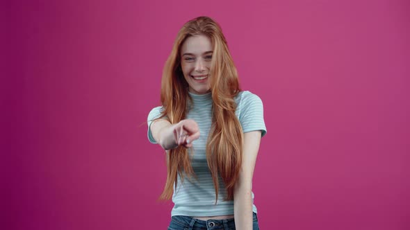 The Redhaired Young Woman with Blue Eyes Expresses Her Amazement By Displaying a Wide Smile and alt