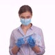 Woman showing sterile medical mask, COVID-19 pandemic - VideoHive Item for Sale