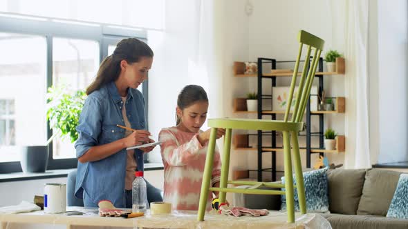 Mother and Daughter with Ruler Measuring Old Chair alt
