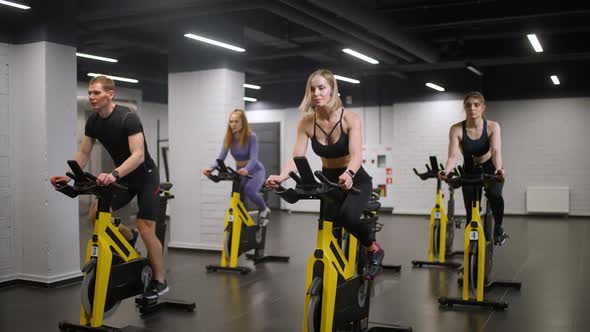 Wellness Group of People is Engaged on a Spin Bikes Performs Aerobic Endurance Training on the alt