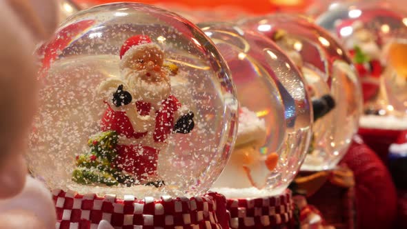 Christmas snow globes on display in a store