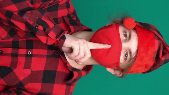 Secret Teen Santa Hat Saying Hush Be Quiet with Finger on Lips Shhh Gesture in Medical Face Mask alt