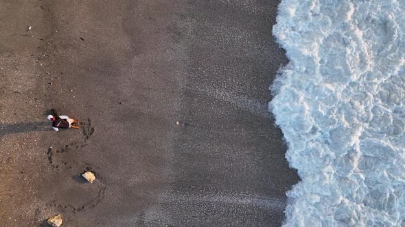 A Man Searches for Gold After a Storm Aerial View 4 K Turkey Alanya alt