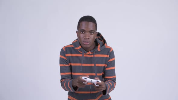 Young Stressed African Man Playing Games and Losing alt