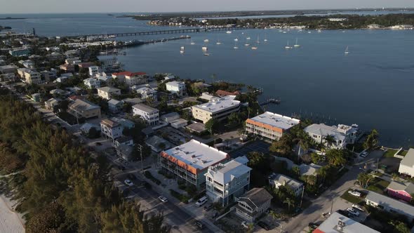 aerial turning to reveal the docked yachts in the channel in Bradenton, Florida near Cortez Beach alt