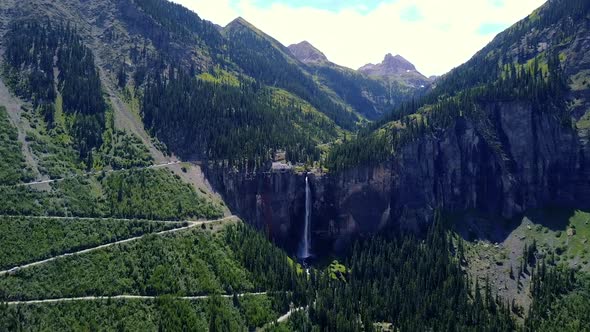 Aerial View of Drone Flying Toward Mountain Stream Waterfall in Colorado  alt