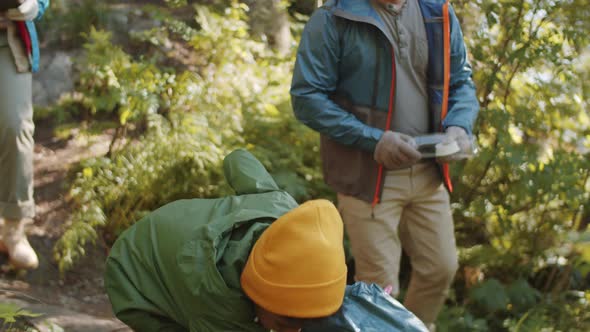 Multiethnic Parents and Kid Cleaning Up Campground in Forest, Stock Footage