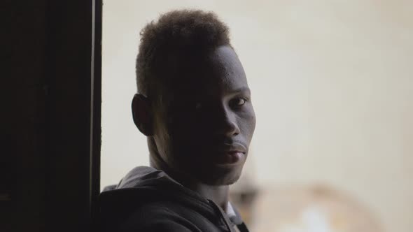 Confident attractive young black african amn staring at camera alt