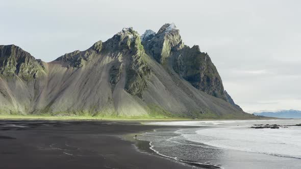 Drone Of Man On Black Beach Under Vestrahorn Mountain alt