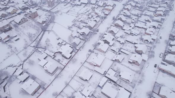 Aerial view of the snow village with private houses and garden plots at winter alt