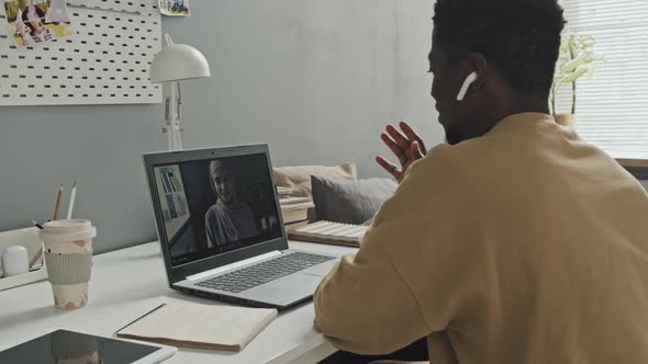 African American Man Having Online Lesson with Muslim Teacher at Home alt