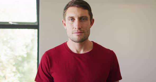 Portrait of happy caucasian man spending time alone at home alt