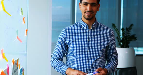 Smiling male executive in office alt