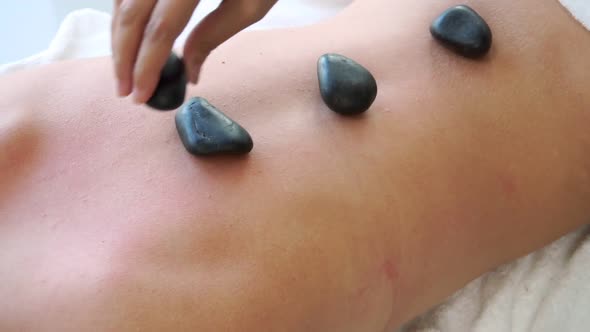 Hot Stone Massage Treatment By Therapist in Spa alt