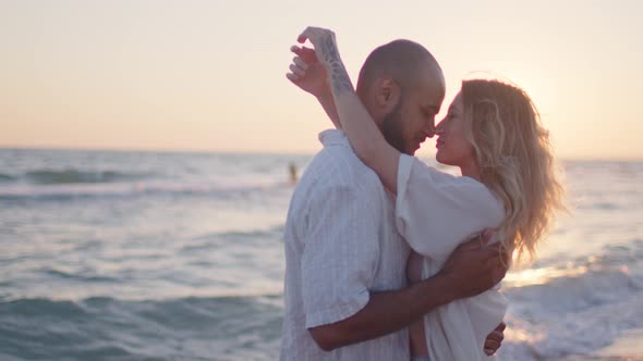 Young Couple in Love Looking at Each Other at the Beach