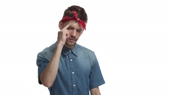 Handsome Caucasian Male Hipster with Beard Red Headband Over Forehead Saluting at you and Smiling