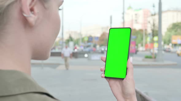 Close Up of Woman Using Smartphone with Green Screen Outdoor alt