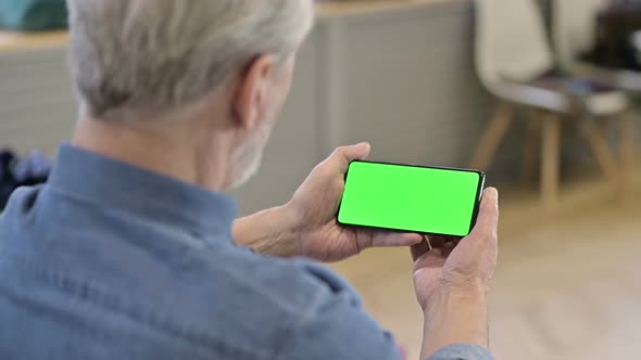 Old Man Watching Video on Chroma Key Smartphone alt
