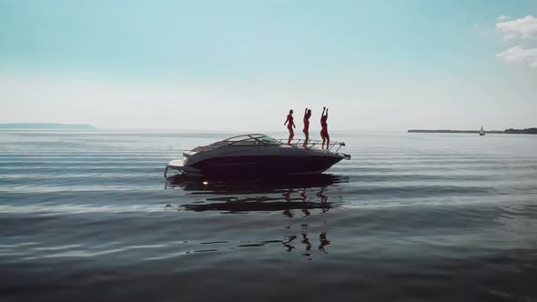 Aerial View Three Beautiful Women Dancing They Had a Party on a Motor Yacht alt
