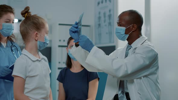 Nurse and Medic Analyzing x Ray Exam Results at Checkup Appointment alt