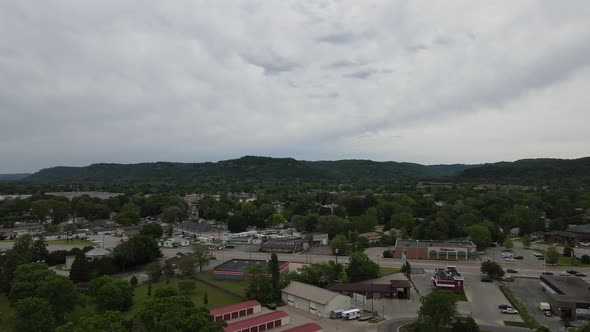 Drone view of midwest city with bluffs protecting the diverse neighborhood with gray clouds in sky.