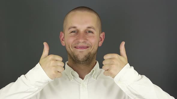 Funny Handsome Guy Smiles and Shows Thumb Up with Both Hands