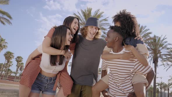 Group of Young People of Different Races Laughing and Having Fun Outdoors alt