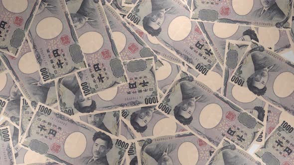 1000 Japanese yen bills background. Many banknotes. alt