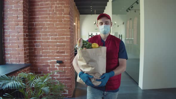 Close Up Cardboard Box with Food in Hands in Medical Gloves alt