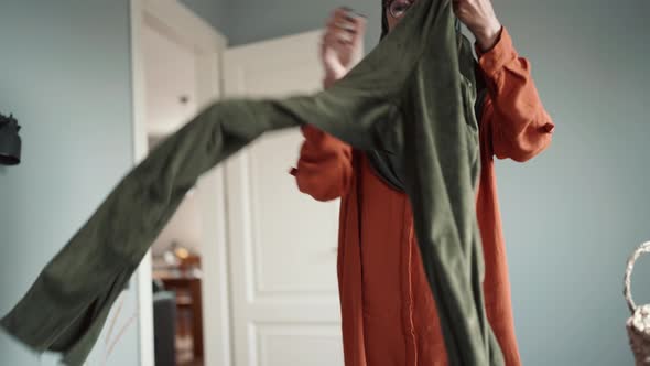 Cheerful Muslim woman wearing eyeglasses stacking things alt