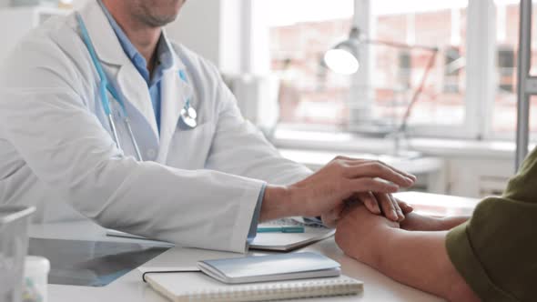 Doctor Comforting Patient Holding Hands alt