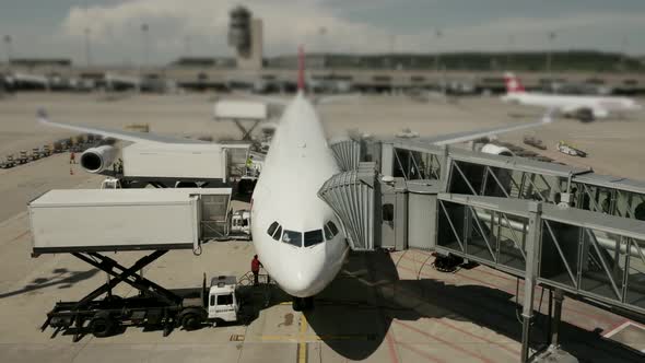 Commercial Airplane Standing at Airport Terminal alt
