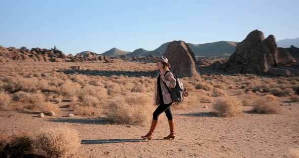 Young Woman Is Hiking in Desert Rocky Park in Summer on Sunrise. Nature  alt
