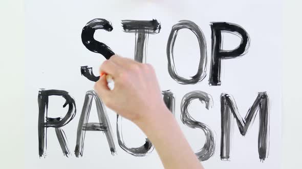 Timelapse. Close-up, Hand Writes Slogan - Stop Racism - with Brush, Using Black Watercolor Paint on alt