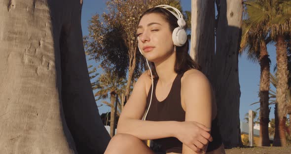 Woman On Sunny Beach In Headphones alt