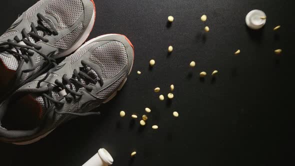 DOPING: Plastic bottle with pills falls near a sneakers