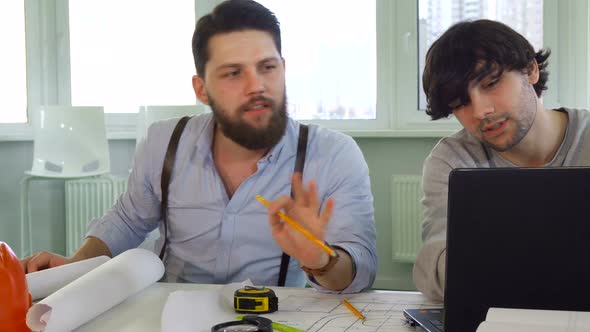 Architects Discuss Something on Laptop