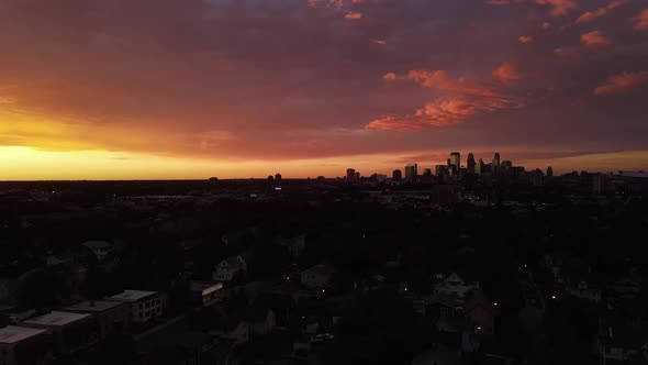 colorful sunset over minneapolis, downtown at the distance, summer time sunset alt
