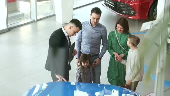 Mother Father and Child Buying Car at Dealership a New Family Auto alt