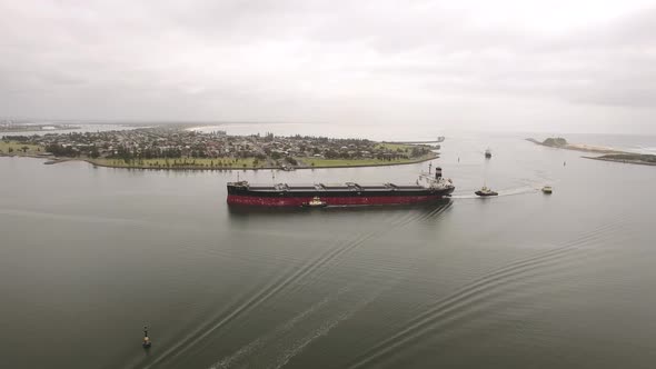 Drone footage of Newcastle harbour and a ship getting transported in. alt