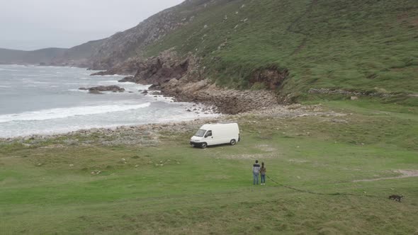 Camper van motorhome view on a sea landscape wild beach and couple living van life social distancing alt