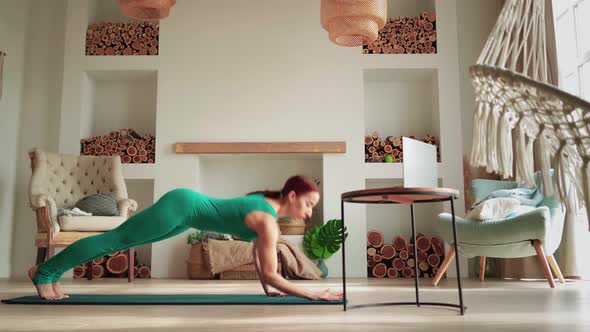 Woman in Sportswear Doing Fitness Exercises Help Her Instructor Online on Laptop alt