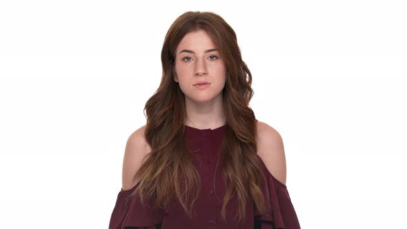 Portrait of Young Woman Being Shocked Screaming in Anxiety Covering Open Mouth with Hands Isolated alt