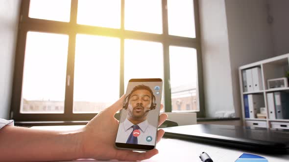 Hand Holding Smartphone with Video Call at Office alt