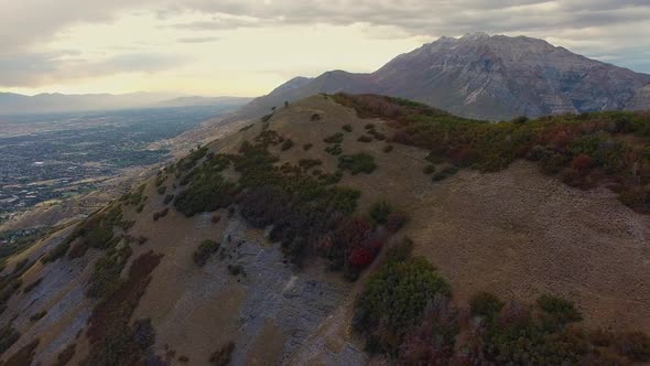 Aerial view on hillside above city during Fall. alt