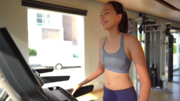 Woman run on treadmill in gym alt